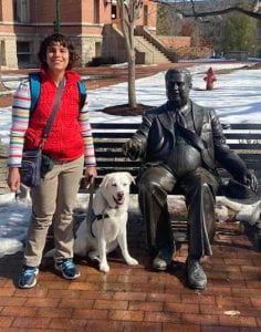 Adria and her service dog Lucy stop by the Herman B Wells statue on the IU Bloomington campus.