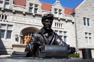 Statue of Ernie Pyle at his typing desk is situated in front of Franklin Hall on the IU Bloomington campus.