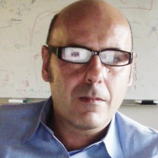 A photo of a man with glasses.,