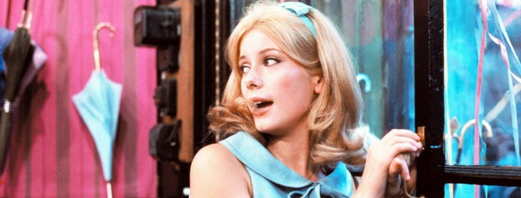 Still image from The Umbrellas of Cherbourg directed by Jacques Demy.
