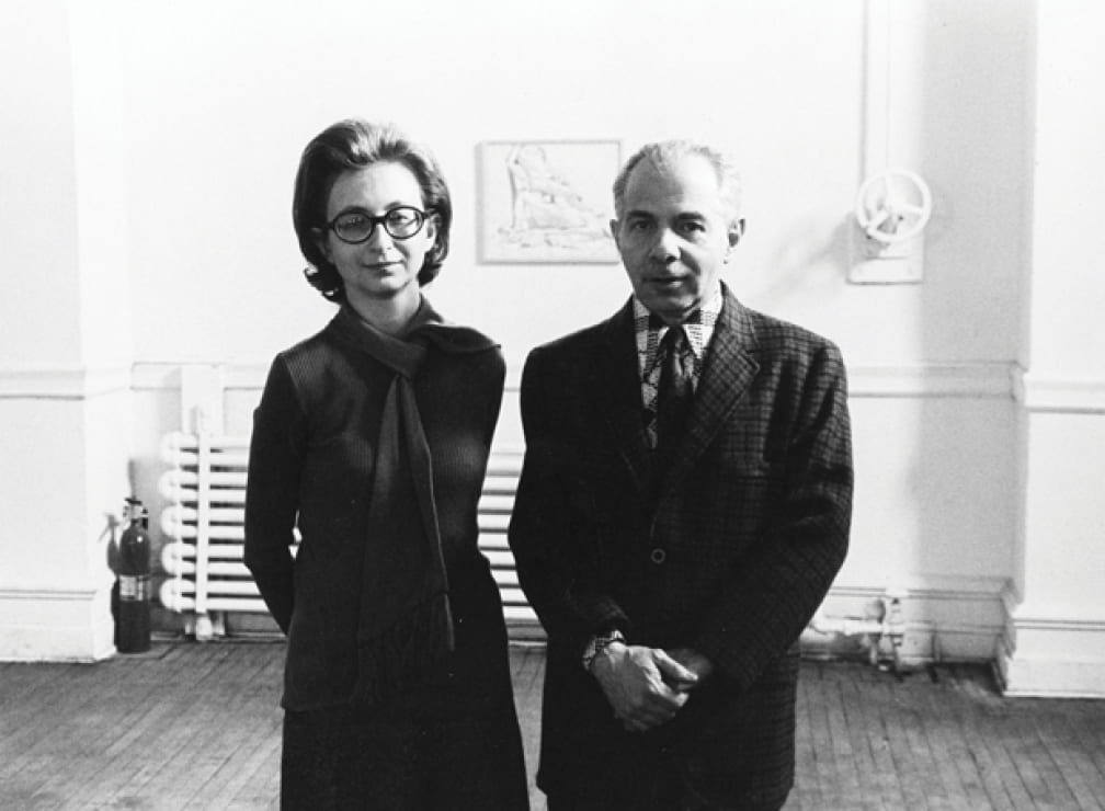 Dorothy and Herbert Vogel at The Clocktower with a drawing by Philip Pearlstein behind them, 1975.