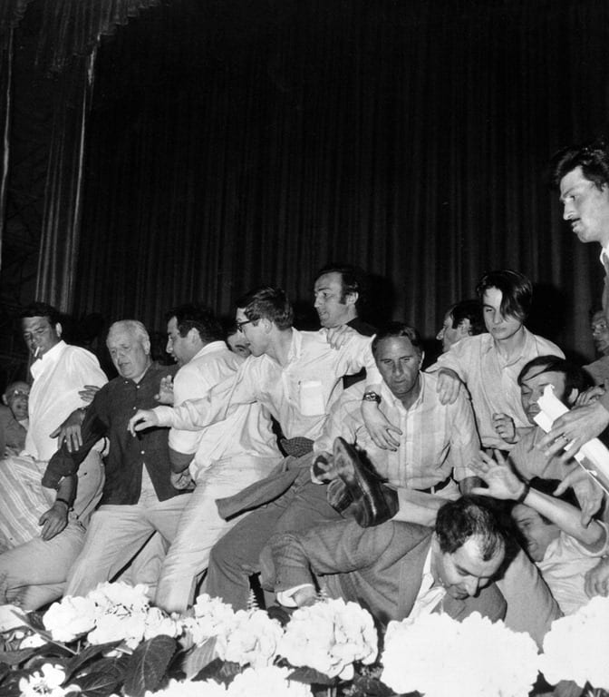 Godard loses his glasses and Truffaut tumbles over in an attempt to rush the stage and prevent the screening of Carlos Saura's Peppermint Frappé at the Cannes Film Festival, 1968