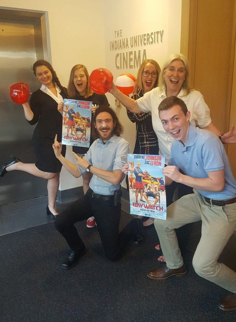 Kathie, second to the right, with other volunteers and house managers while holding promotional materials for Baywatch (2017)