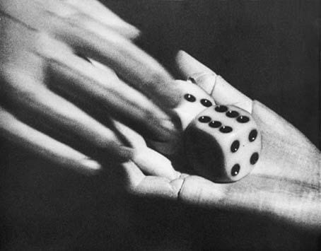marionette hands hold a pair of dice