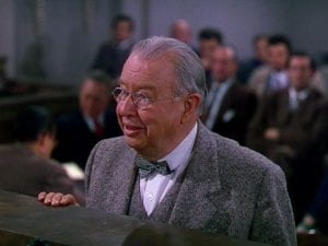 Charles Coburn talking to a judge in a courtroom
