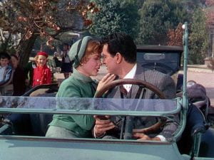 Rock Hudson and Piper Laurie about to kiss in a car