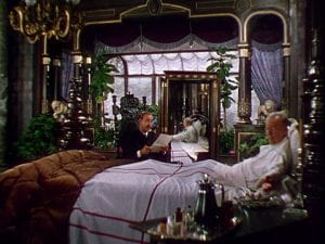 Charles Coburn in bed in his lavish bedroom