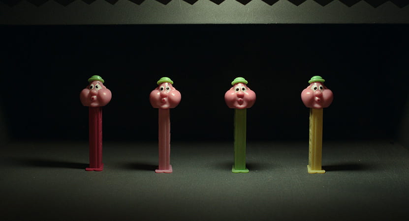 Four Pez dispensers lined up by each other