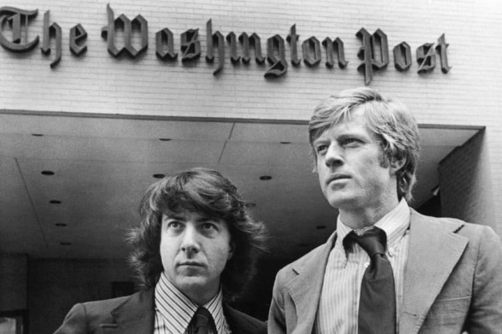 Black-and-white image of two men standing outside the Washington Post office building