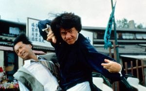 Jackie Chan fighting off two men