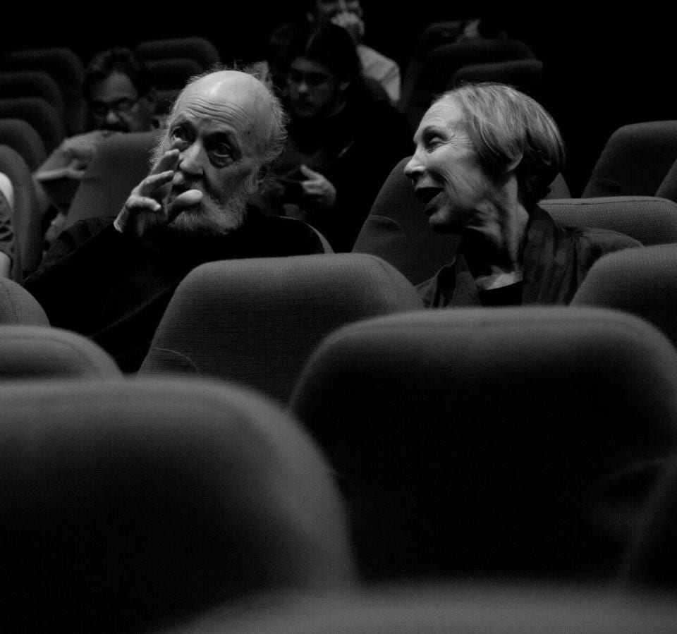 A man and woman sitting in the IU Cinema and talking