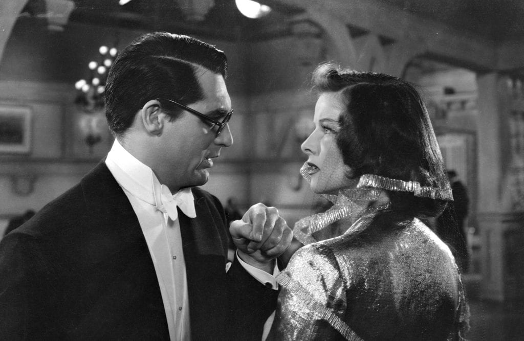 Cary Grant and Katharine Hepburn look at each other in anger