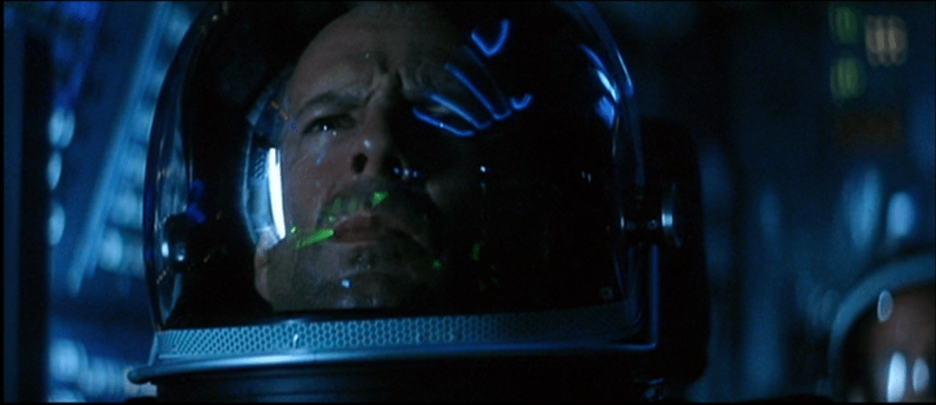 Extreme close up of Bruce Willis wearing a space helmet, some blue and green lights reflected on its surface. His face says, "I know what I have to do."