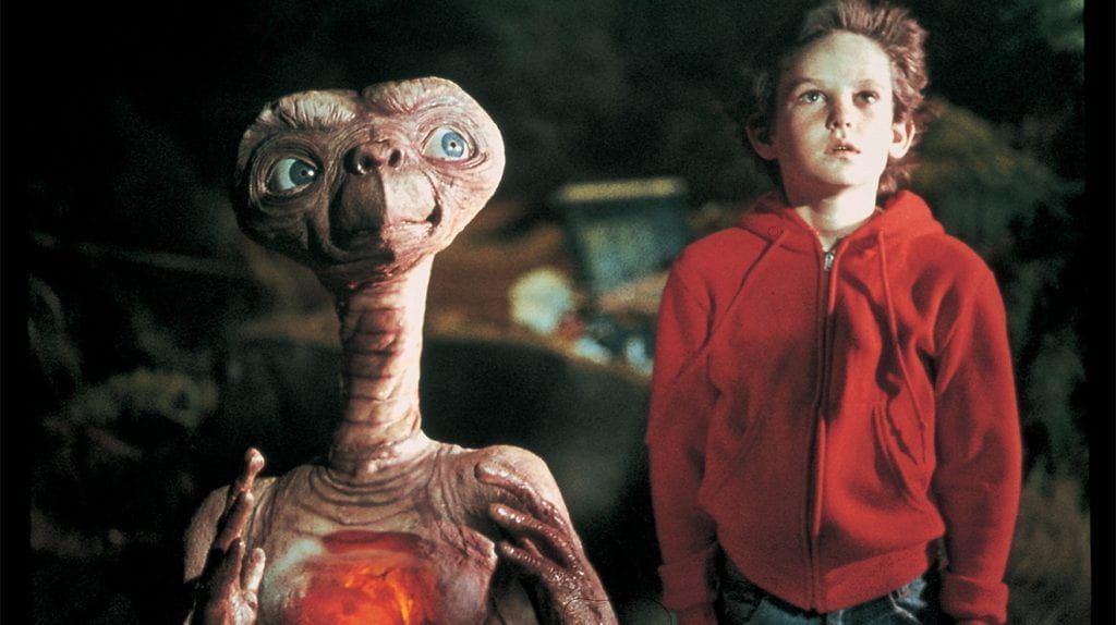 E.T. and Elliott stand by each other and look up in the sky