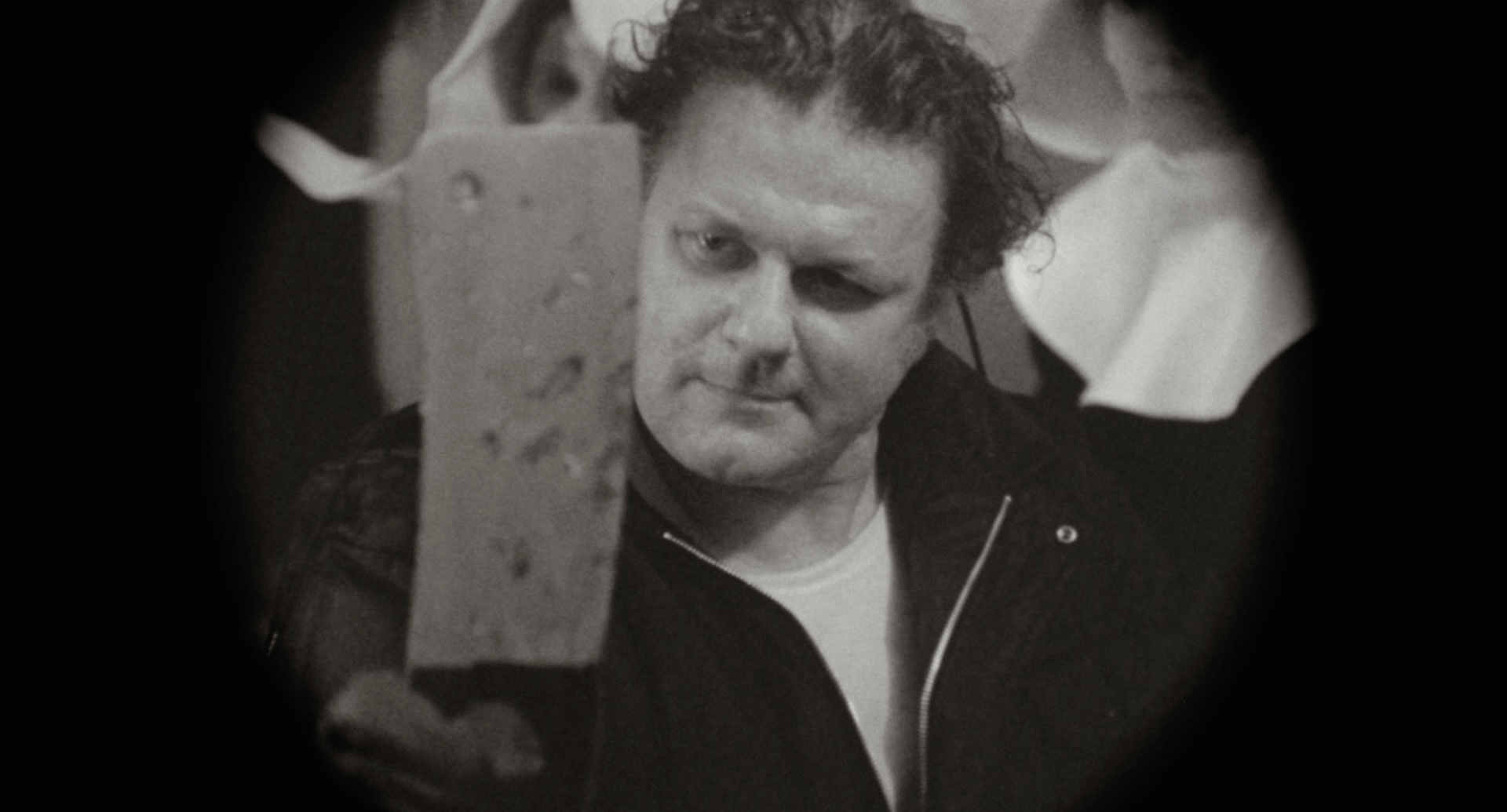 Charles Durning holds up a cleaver
