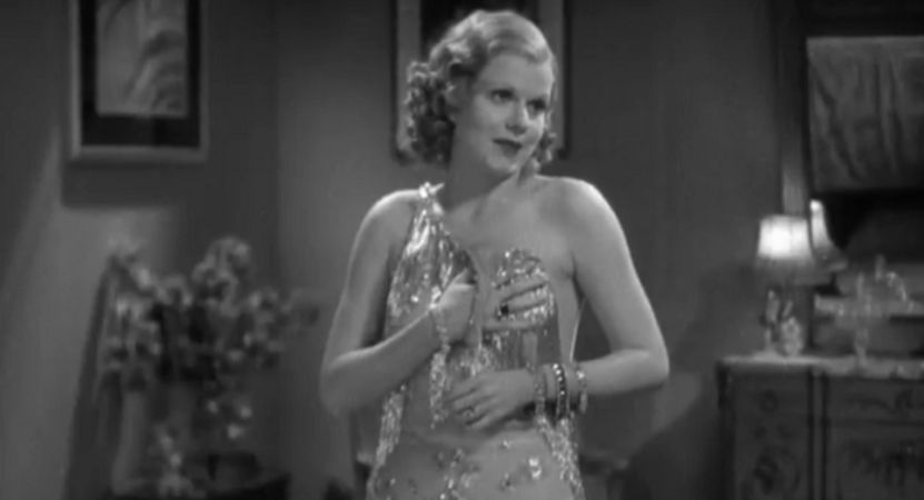 Jean Harlow holds up her dress with one strap undone