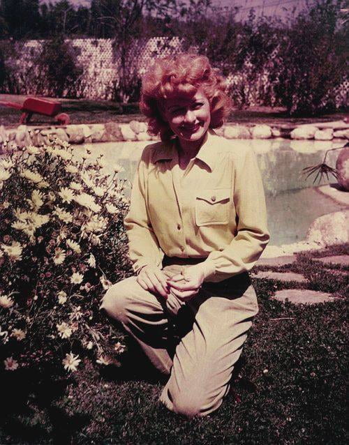 Lucille Ball smiling in her garden