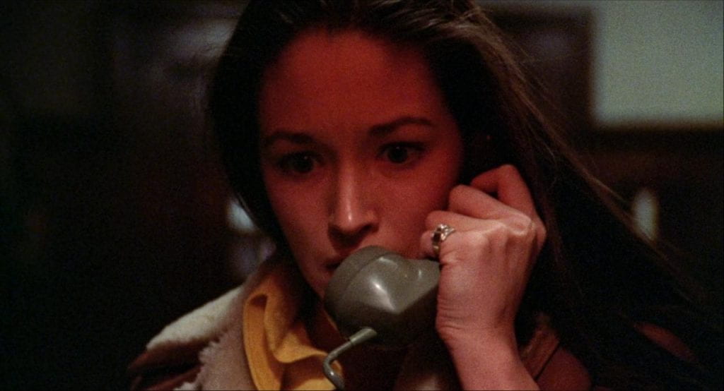 Olivia Hussey looks distressed while answering a phone
