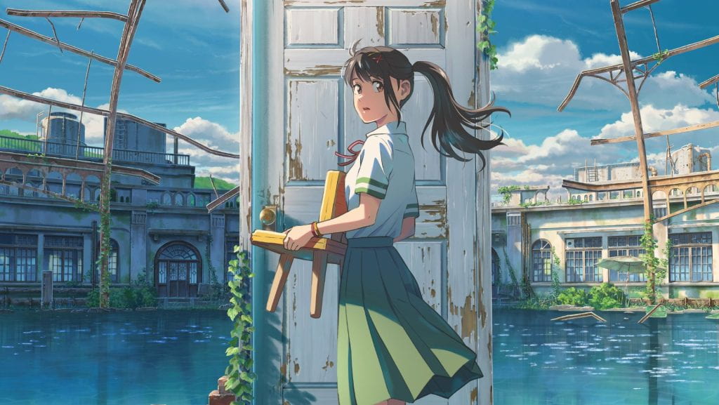 A teenaged girl stands in front of a door on a body of water while holding a chair