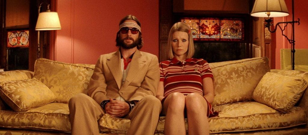 Margot and Richie Tenenbaum sitting next to each other on a couch