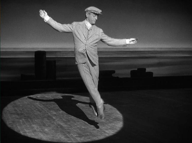 James Cagney leaps in the air while dancing on a stage as George M. Cohan