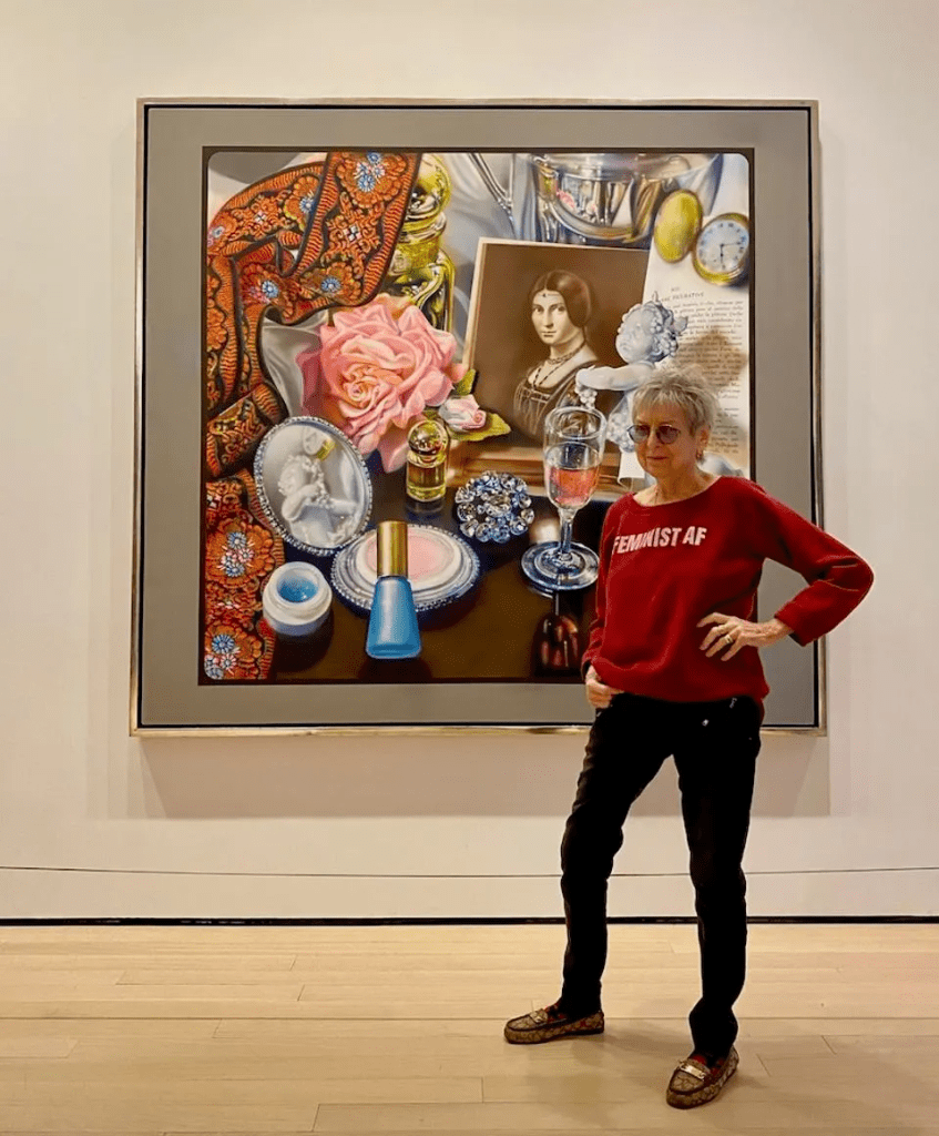 Audrey Flack poses next to one of her artworks hanging at the MoMA