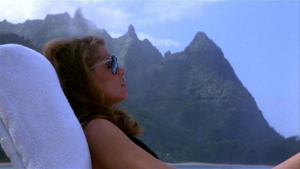 Kathleen Turner sunbathes on a beach