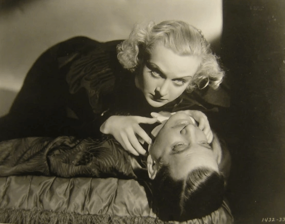 Carole Lombard strangles a man on a bed