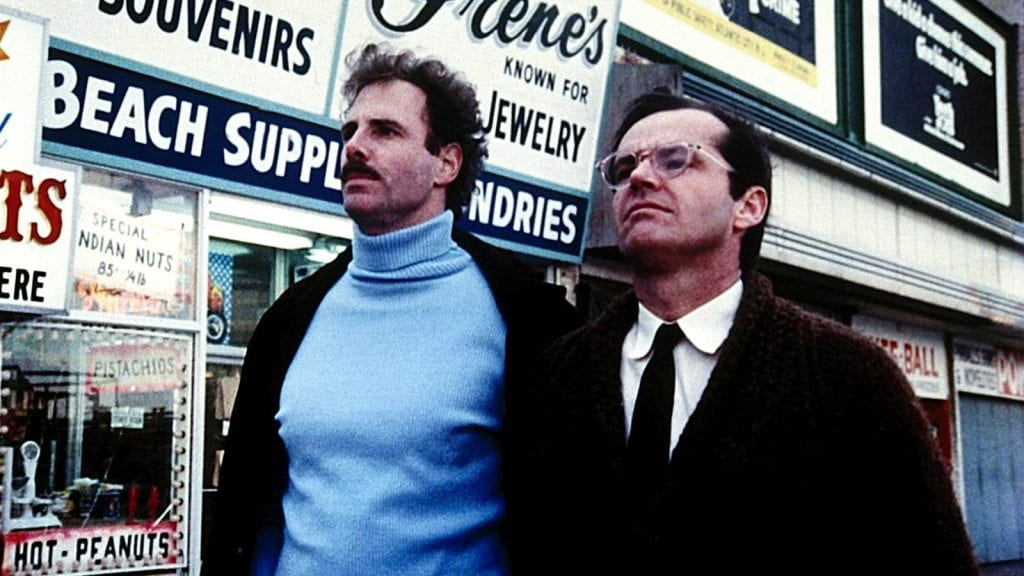 Bruce Dern and Jack Nicholson stand on a street sidewalk