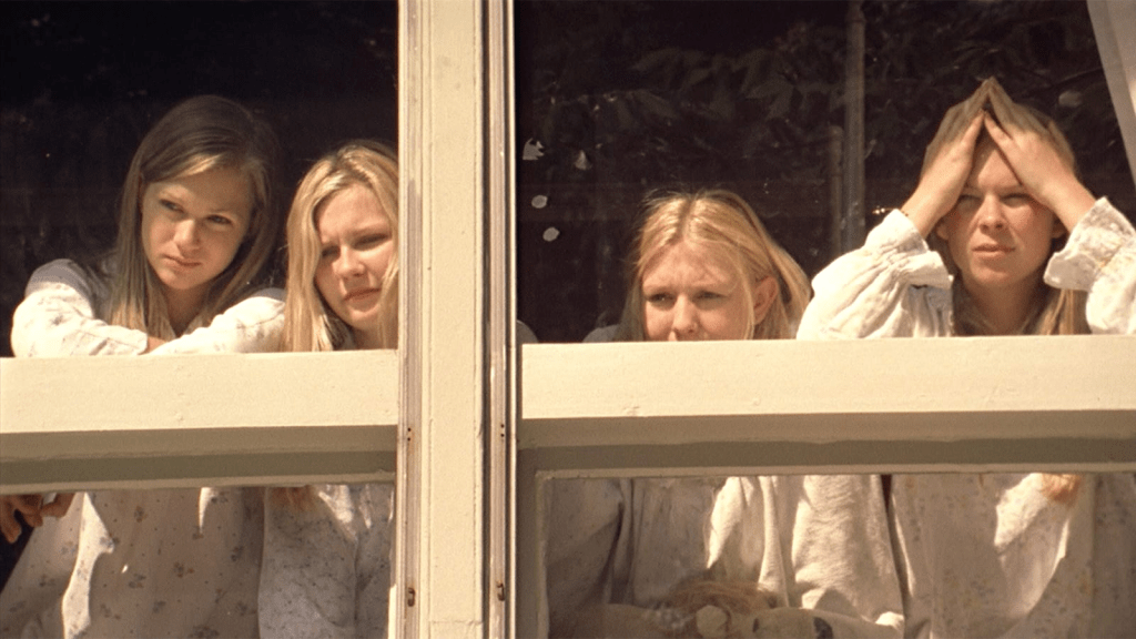 Four of the Lisbon sisters looking out of a window