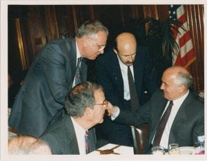  Hamilton standing, shaking hands with the seated Mikhail Sergeyevich Gorbachev, former President of the USSR; Senator George Mitchell at front left