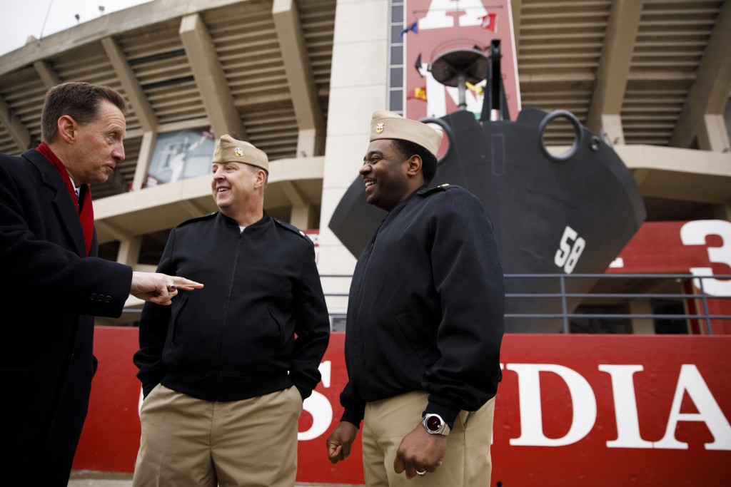 USS Indiana (SSN-789) Commander Jesse J. Zimbauer, center, and Master Chief Lafrederick Herring speak with Indiana University Assistant Vice President for Strategic Partnerships Kirk White, left, in front of the prow and mast of the USS Indiana (BB-58), a WWII-era battleship, at Memorial Stadium at Indiana University Bloomington on Tuesday, Jan. 10, 2017. The USS Indiana (SSN-789) is a Virginia-class submarine expected to be christened in April and commissioned sometime in 2018.