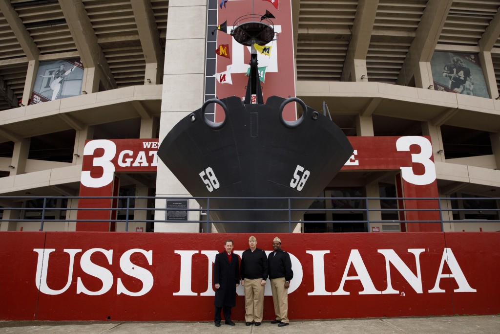 Indiana University Assistant Vice President for Strategic Partnerships Kirk White, left, USS Indiana (SSN-789) Commander Jesse J. Zimbauer and Master Chief Lafrederick Herring pose for a photo in front of the prow and mast of the USS Indiana (BB-58), a WWII-era battleship, at Memorial Stadium at Indiana University Bloomington on Tuesday, Jan. 10, 2017. The USS Indiana (SSN-789) is a Virginia-class submarine expected to be christened in April and commissioned sometime in 2018.