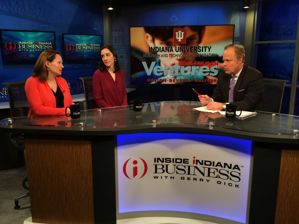 Jennifer Finefield (IURTC) and Elizabeth Hagerman (Rose-Hulman Ventures) sit on one side of a curved desk branded "Inside Indiana Business" across from Gerry Dick, the show's host.