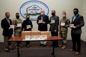 Indiana University Assistant Vice President for Strategic Partnerships Kirk White, far left, led a university group that delivered 1,000 Afghan language phrasebooks to Indiana's Camp Atterbury. The books are being used by military personnel who are helping to resettle the Afghan refugees who are being temporarily housed at the army base. 