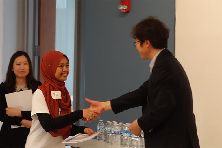 Student accepting award for winning the 2018 Korean Speech Contest