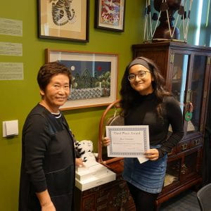 Ria Talukder accepts her award from IKS Director Seung-kyung Kim.