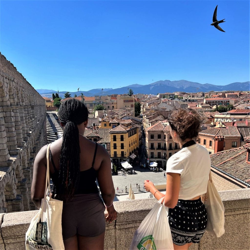 Two students look out over a cityscape in Segovia, Spain