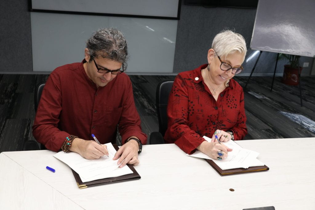 Two people sign an official agreement