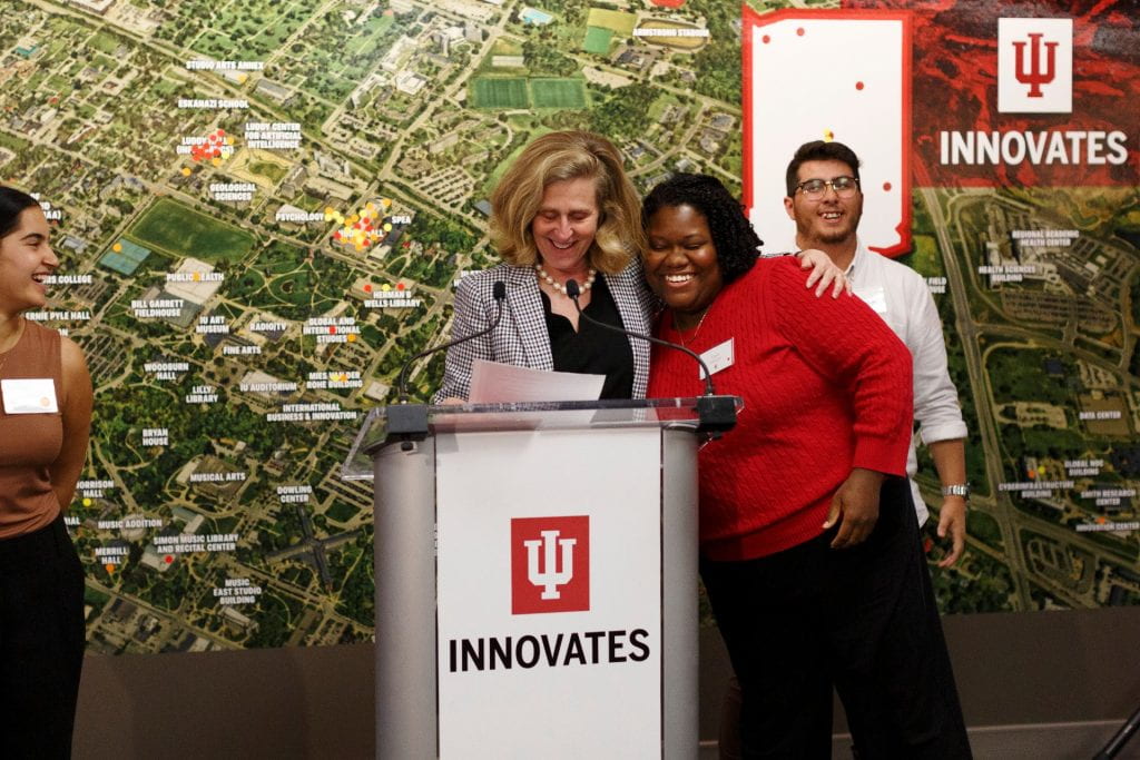 Indiana University President Pamela Whitten, left, introduces Charlie Edmonds, a doctoral student in music education at the IU Jacobs School of Music, at a launch event for the new IU Innovates initiative. The founder of Pocket Methods, Edmonds is one of five nominees for TechPoint's Student Entrepreneur of the Year award. 