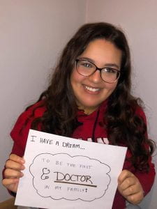 Engage intern Rana Hamad holding a sign that says "I have a dream...to be the first doctor in my family!"