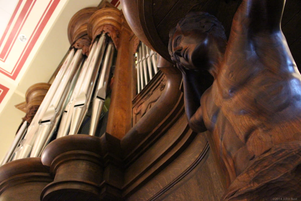 Carving details on organ.