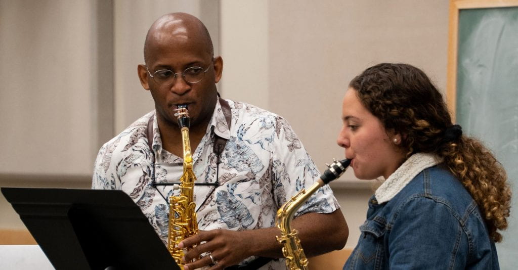 Professor and student play saxophone