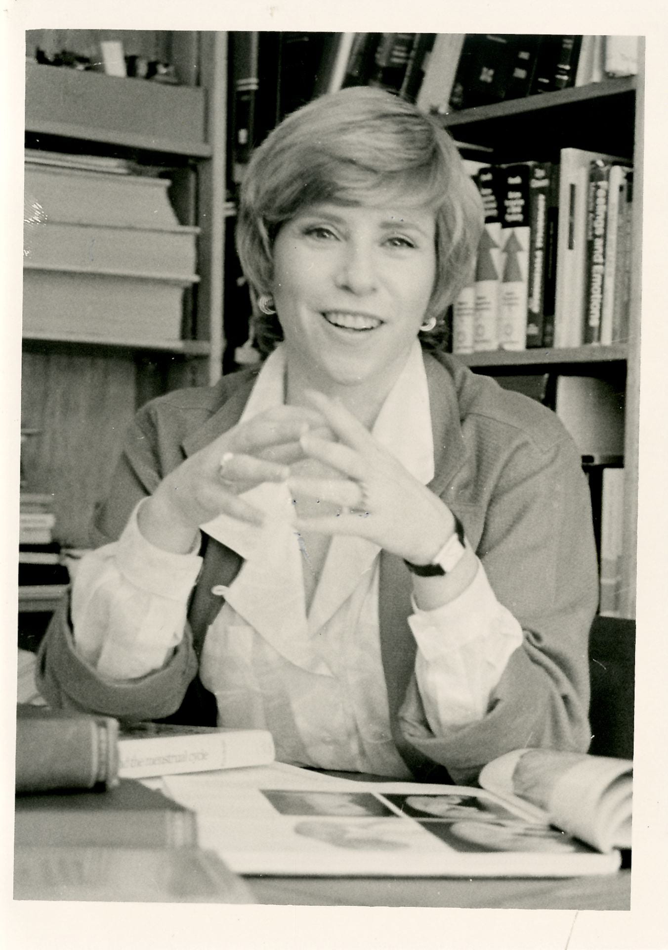 Former director Dr. June Reinisch sitting at her desk.