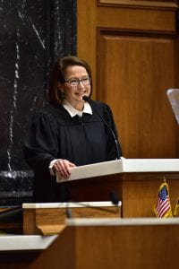 Indiana Supreme Court Chief Justice Loretta Rush delivers the annual State of the Judiciary address. She is wearing a judge's robe and standing behind a podium.