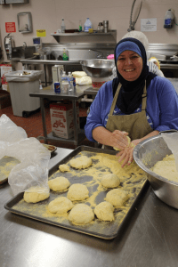Subhiya, a long-time member of the ICGT, bakes bread for the International Festival