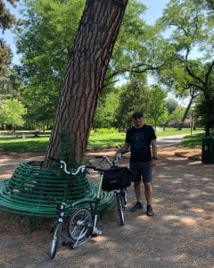 Stefano with his bike at a garden in Bologna, Italy