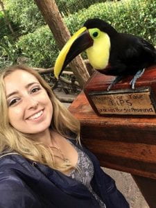 Danielle taking a selfie with a toucan in Costa Rica