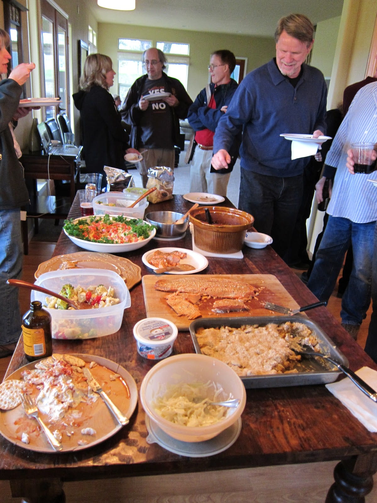 A group of people enjoying a potluck gathering.