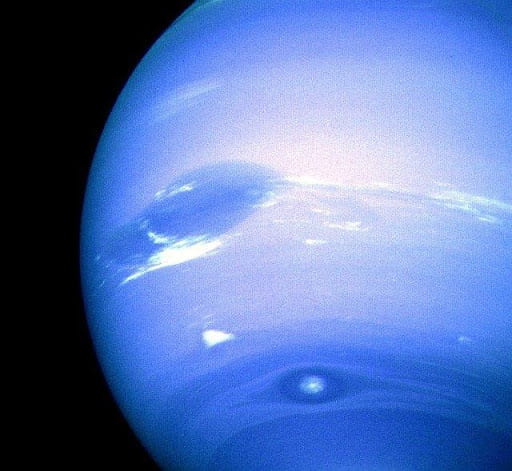 A close up picture of the planet Neptune, a bright blue gas giant.